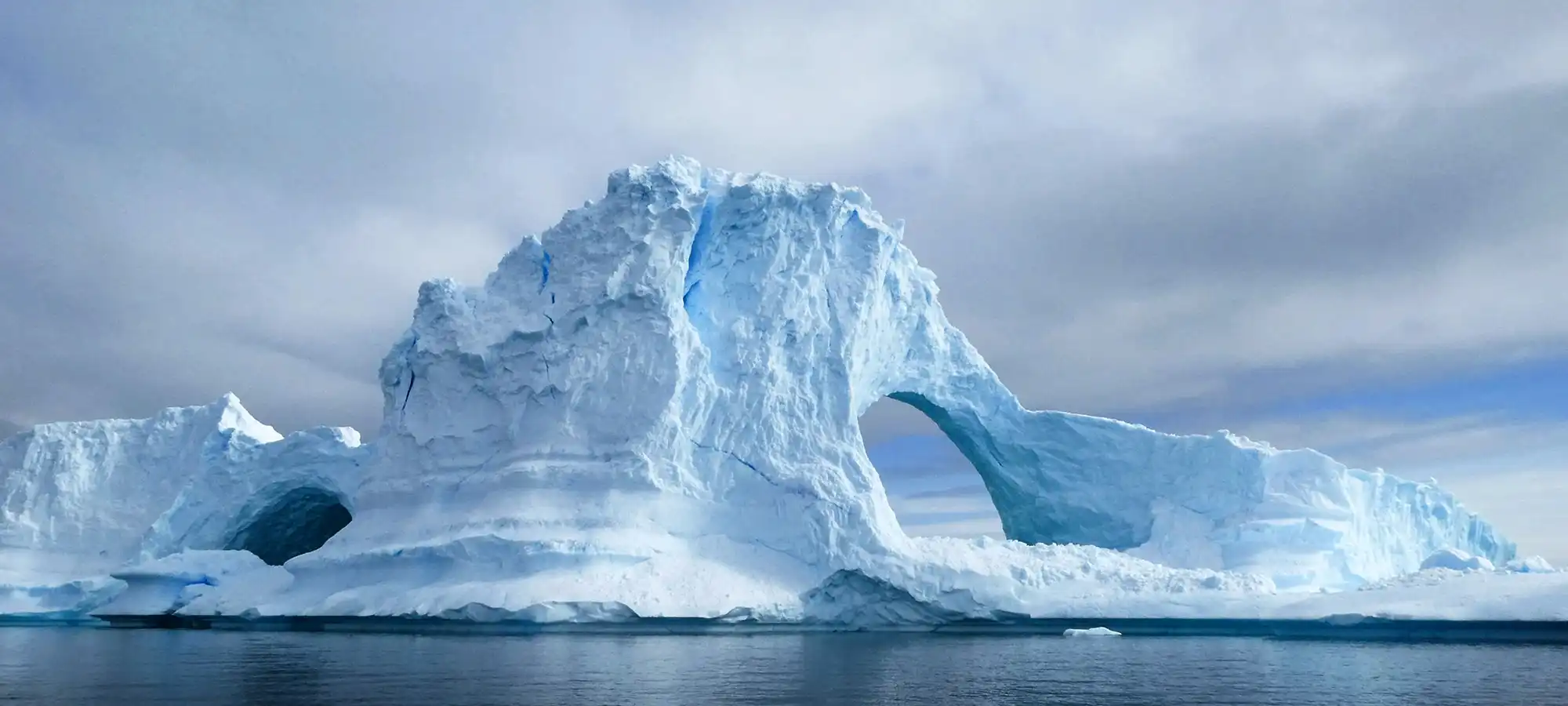 Iceberg tunnel Antarctica - GlobalXplorers